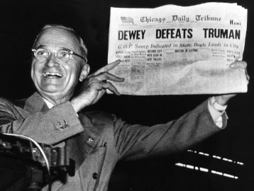 Victorious presidential candidate Pres. Harry Truman jubilantly displaying erroneous CHICAGO DAILY TRIBUNE w. headline DEWEY DEFEATS TRUMAN which overconfident Republican editors had rushed to print on election night, standing on his campaign train platform. (Photo by W. Eugene Smith//Time Life Pictures/Getty Images)